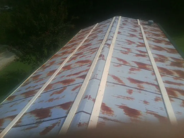 Rusted metal roof panels with new wood purlins before replacement — Storm Damage Roof Repair in Palmyra by Roofing Brothers